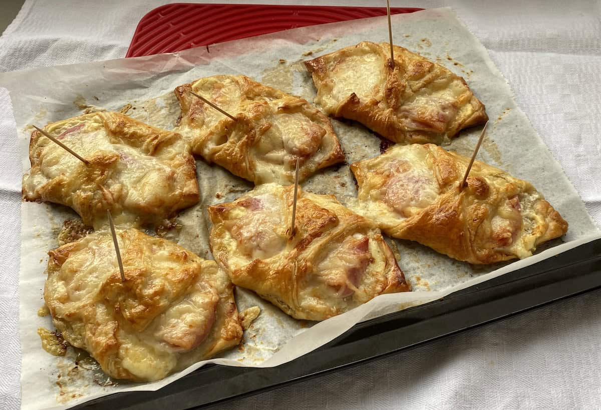 Baked Cheese and Bacon Turnovers on a baking tray.