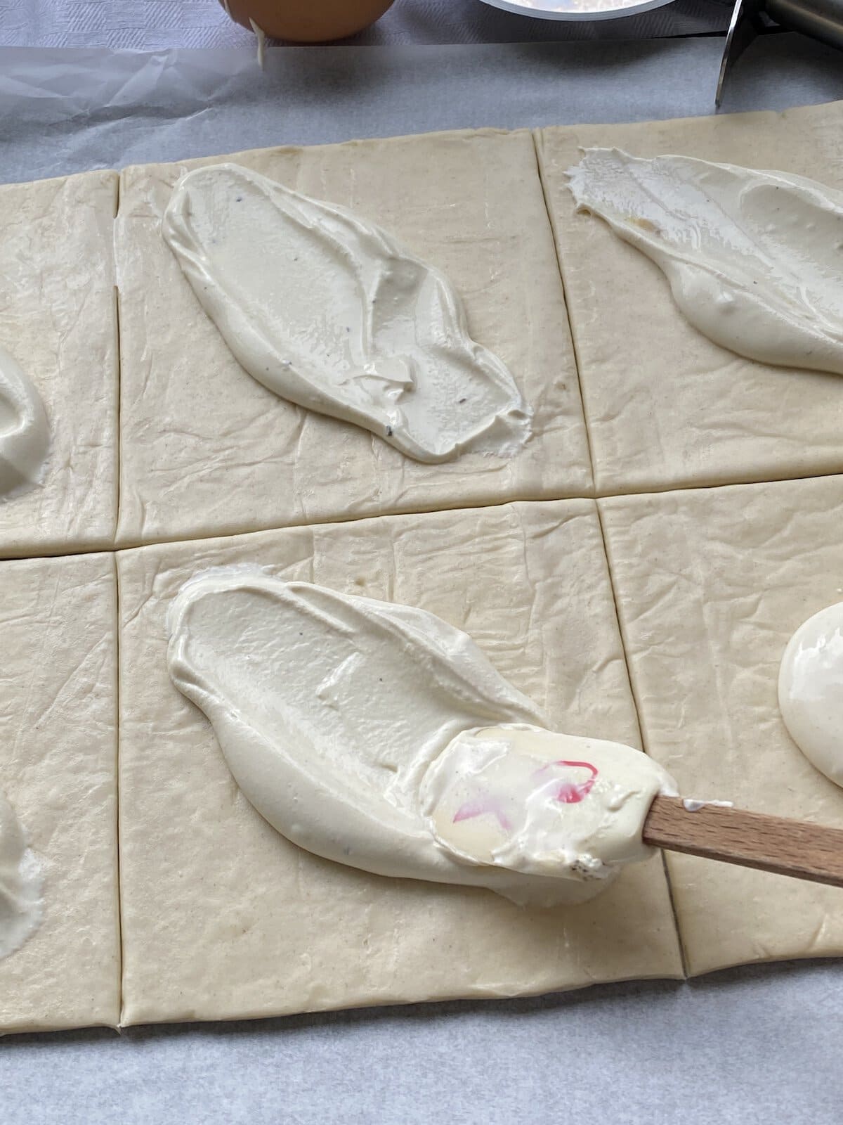 Puff Pastry squares with cream cheese spread in the middle.