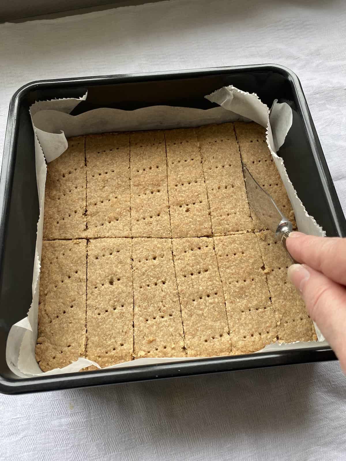 Cut shortbread into portions with a knife.