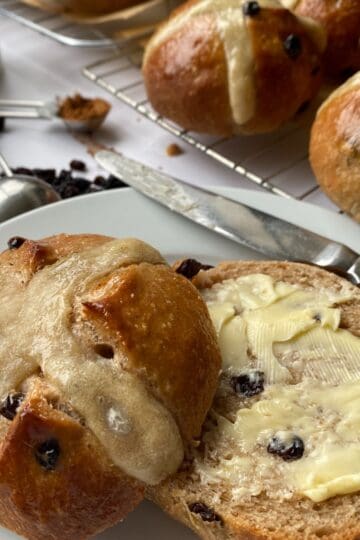 Sliced and buttered Hot Cross Bun.