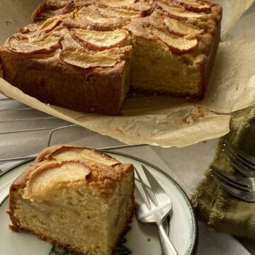 Cake on a plate with a slice cut out.