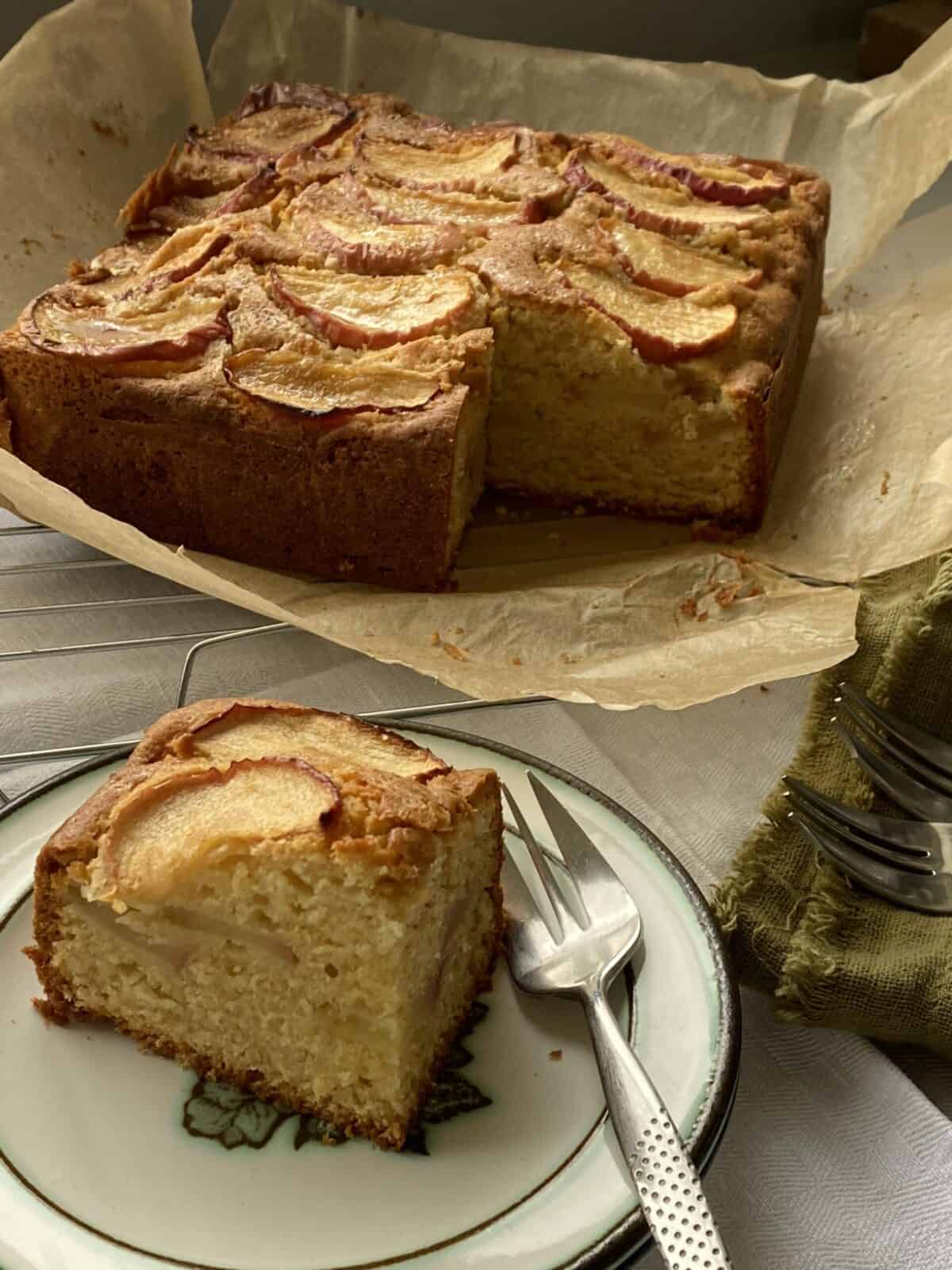 Cake on a plate with a slice cut out.