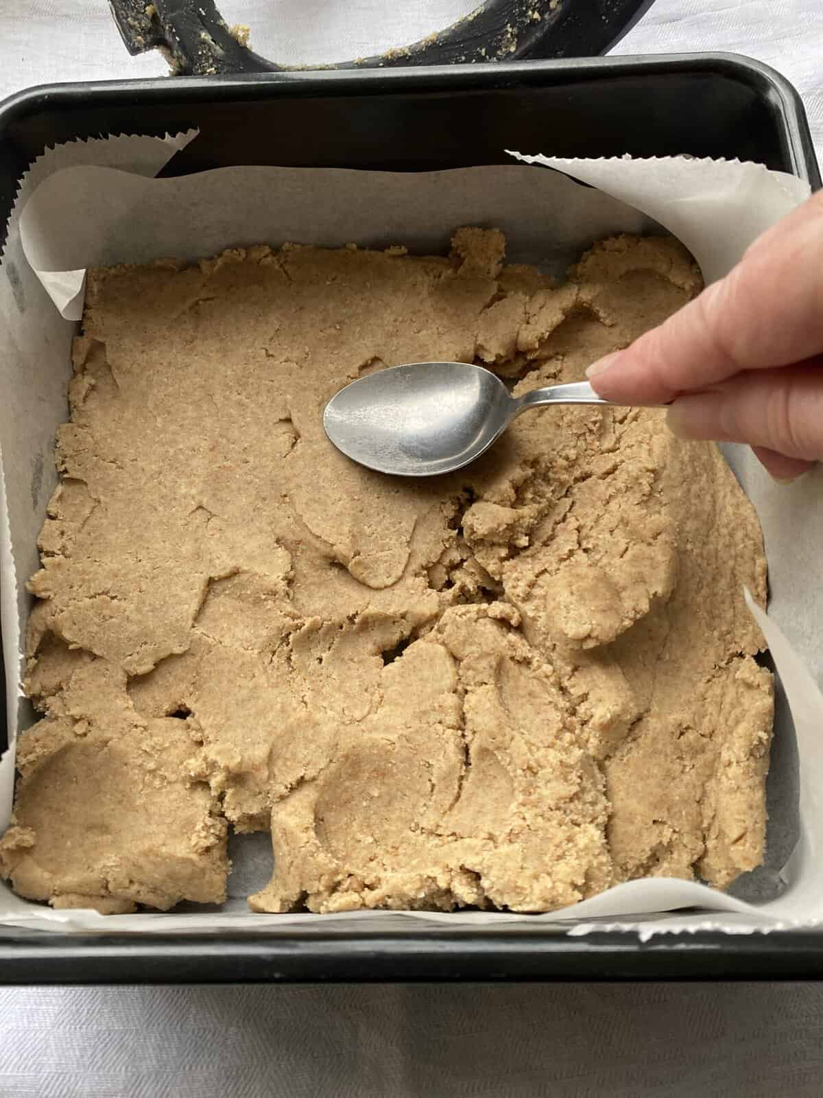 Press down the shortbread dough with the back of a spoon.