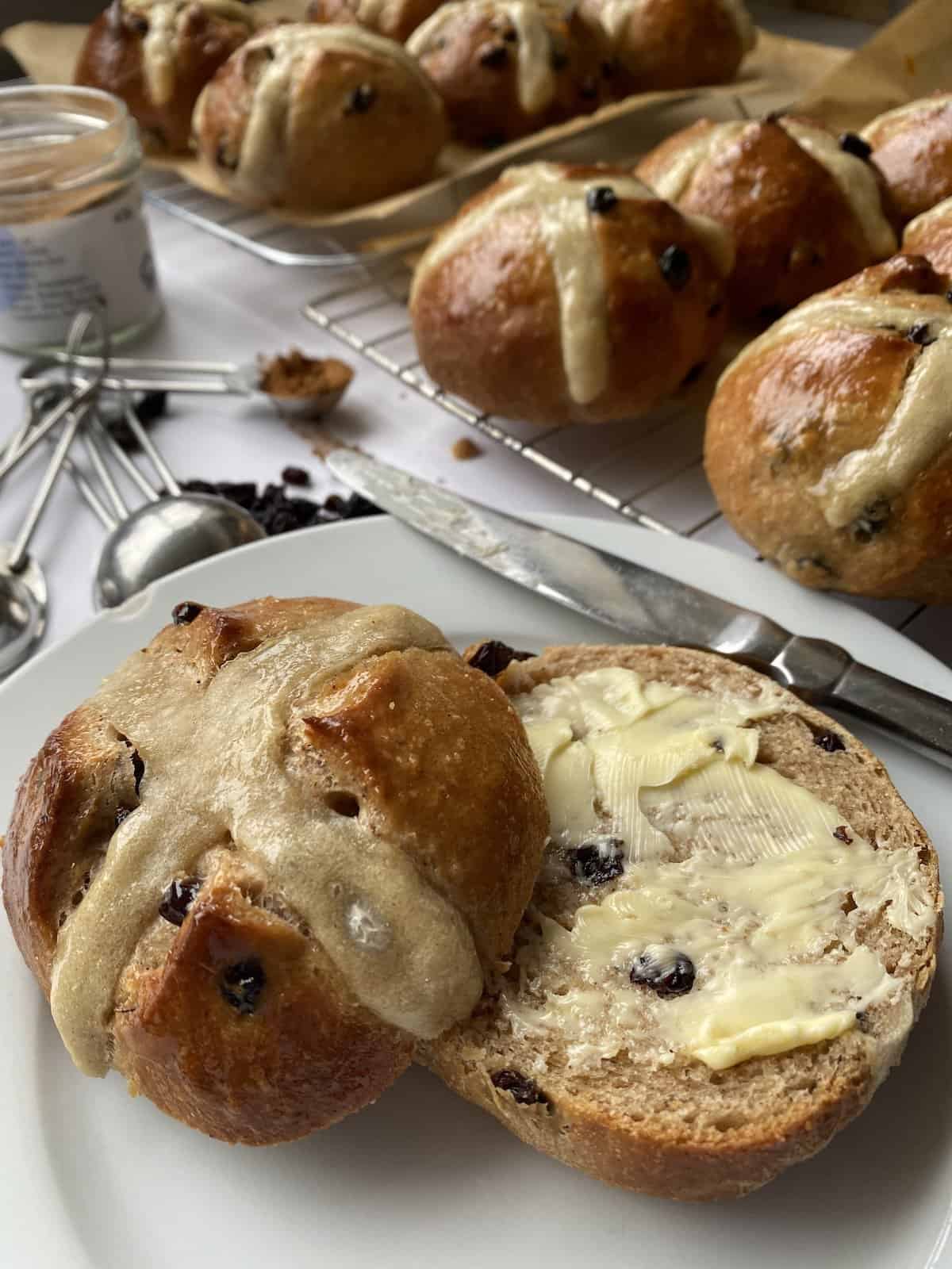 Sliced and buttered Fruit Hot Cross Buns.