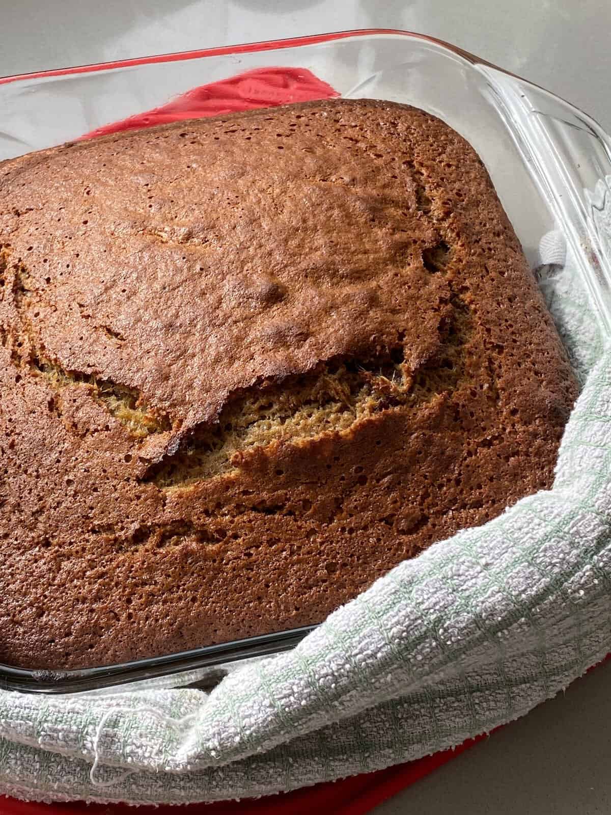 Sticky Toffee pudding in a glass baking dish straight from the oven.