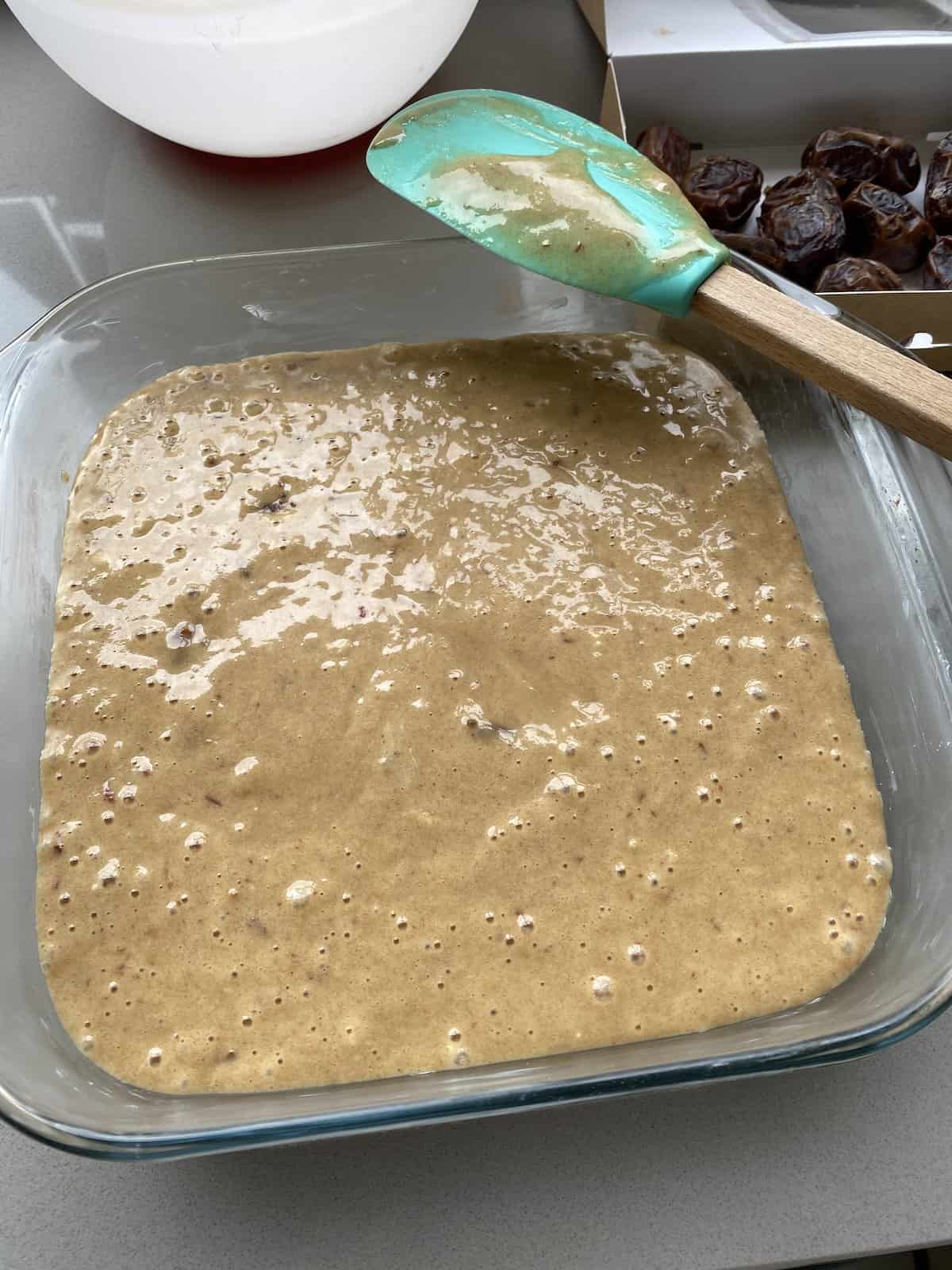 Sticky Toffee Cake batter in a glass oven proof dish.